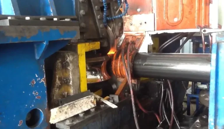 High-frequency induction welding: the pipe passing through the glowing work coil