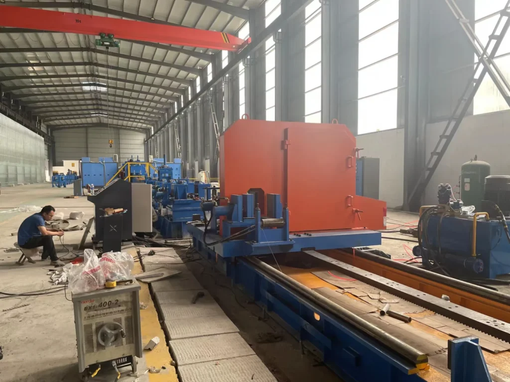 Operator working at the H-beam assembly and welding line