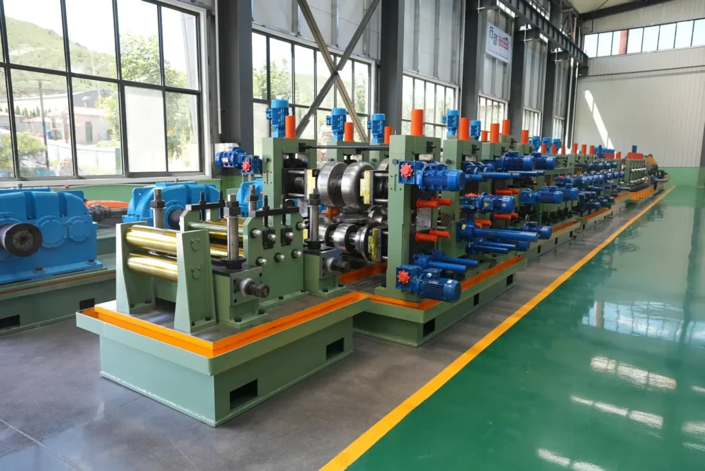 Tube mill stands with finished pipe alongside