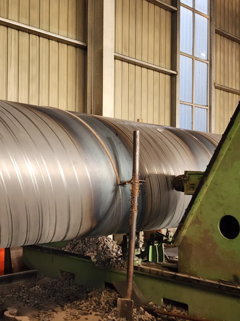 Spiral welded pipe being formed on the mill